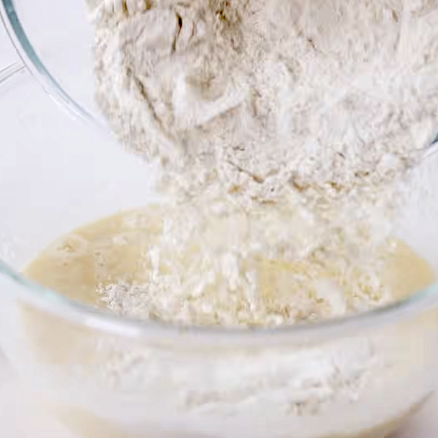 Dry ingredients being added to wet ingredients to make fluffy buttermilk pancakes.