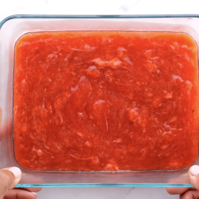 Strawberry pie filling in a glass container.