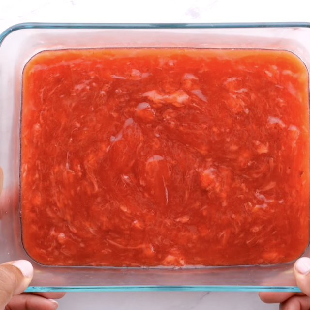 Strawberry pie filling in a glass container.