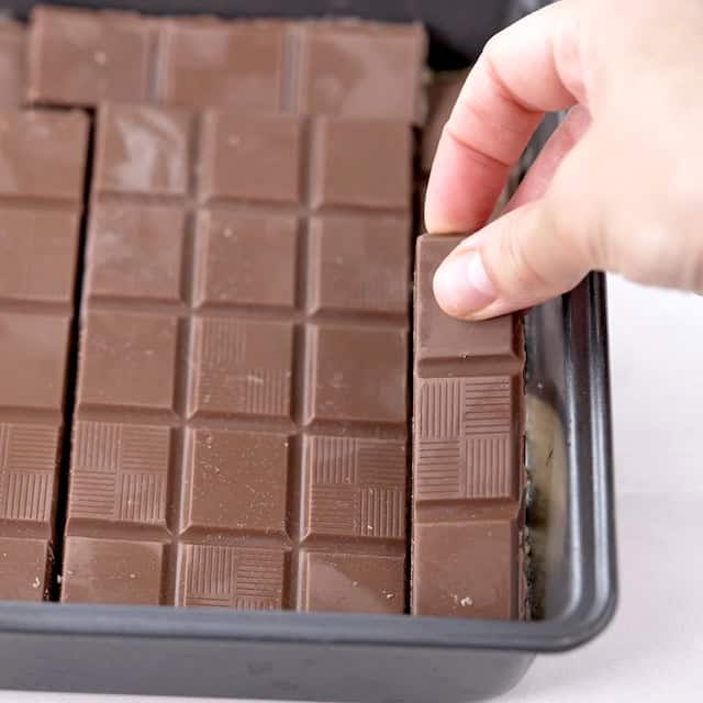 Chocolate being layered on top to make smores bars recipe.