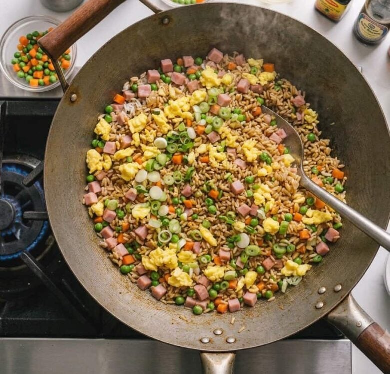 Chinese Fried Rice stirred and combined in the wok, ready to serve.