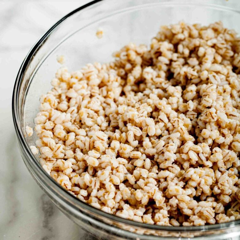 Cooked barley in a clear glass bowl.