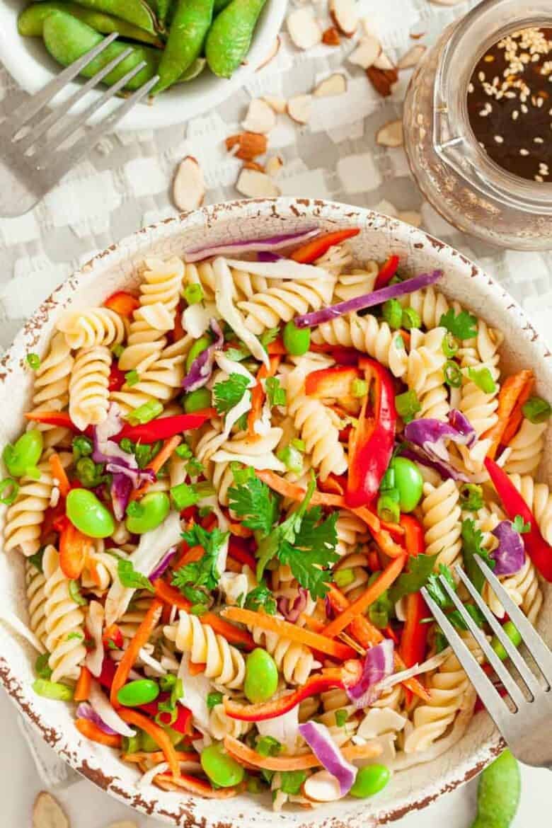 White bowl full of Asian pasta salad.