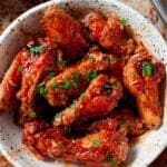 White bowl full of buffalo chicken wings.