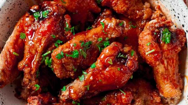 White bowl full of buffalo chicken wings.
