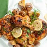 Serving plate full of Greek chicken and potatoes.