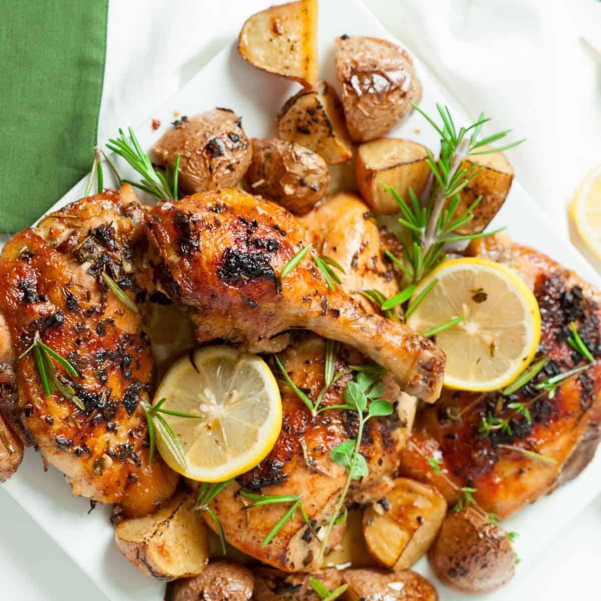 Serving plate full of Greek chicken and potatoes.