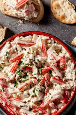 Square image of imitation crab dip in a serving bowl.