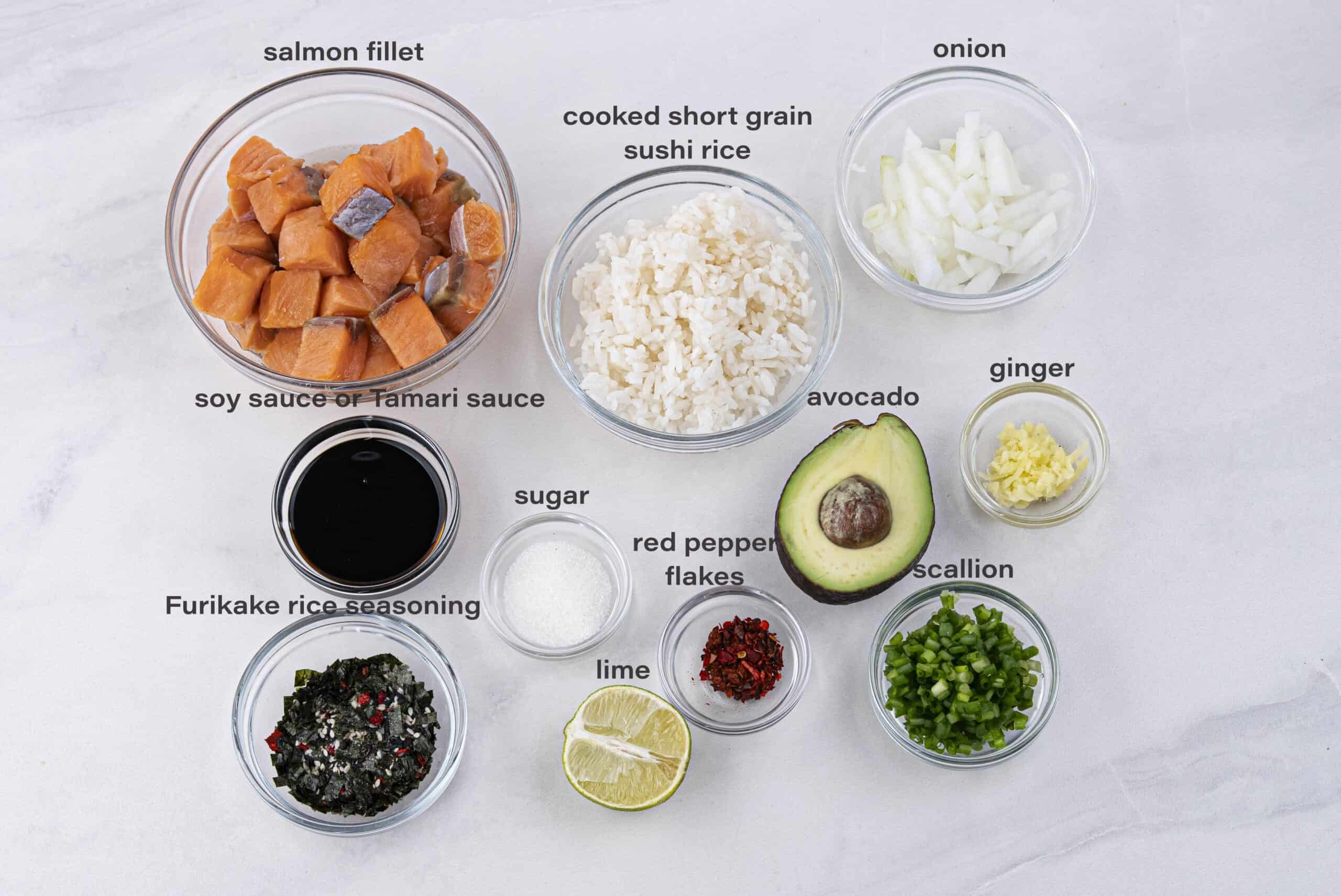 Labeled ingredients needed to make a salmon poke bowl at home.
