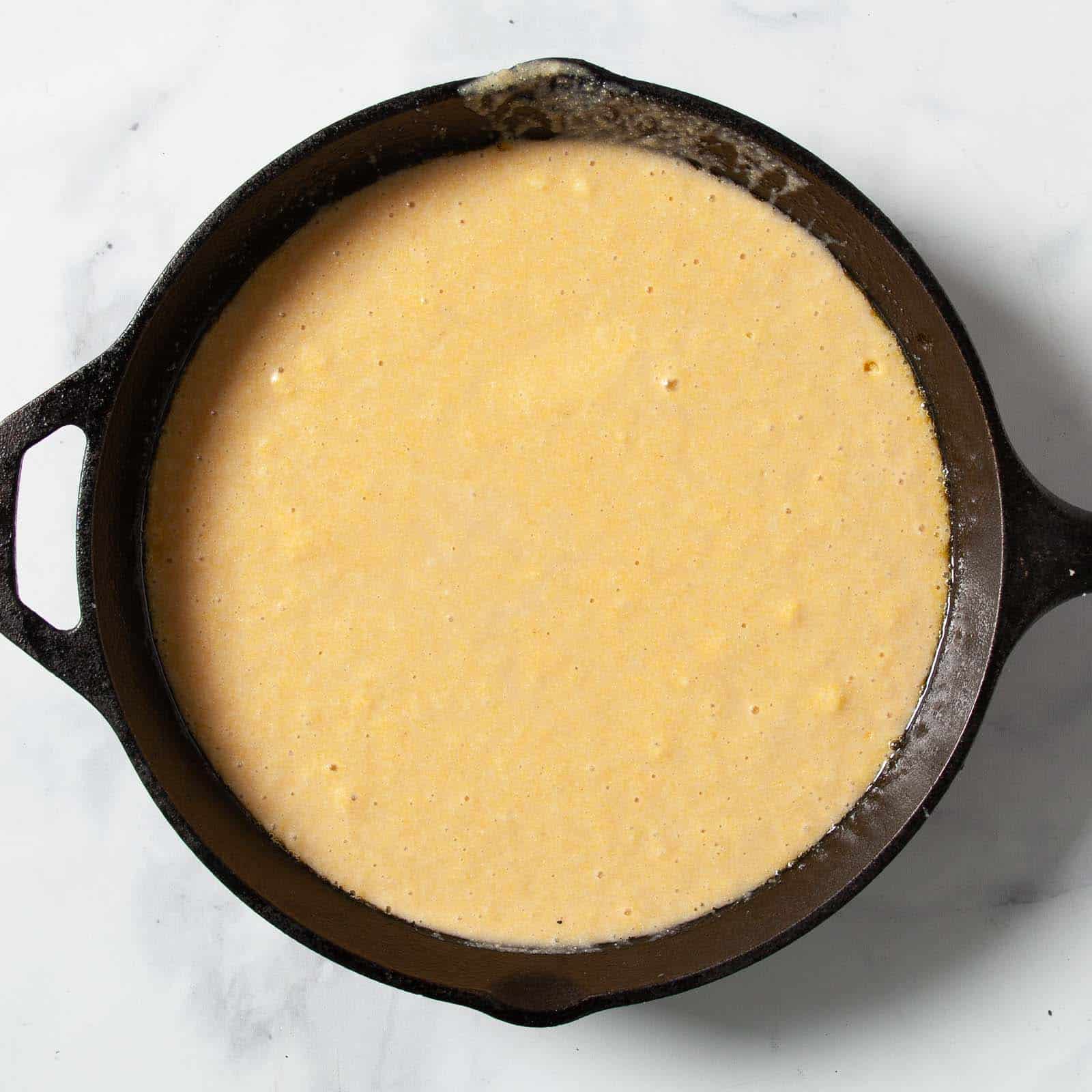 Pouring the batter into the skillet.
