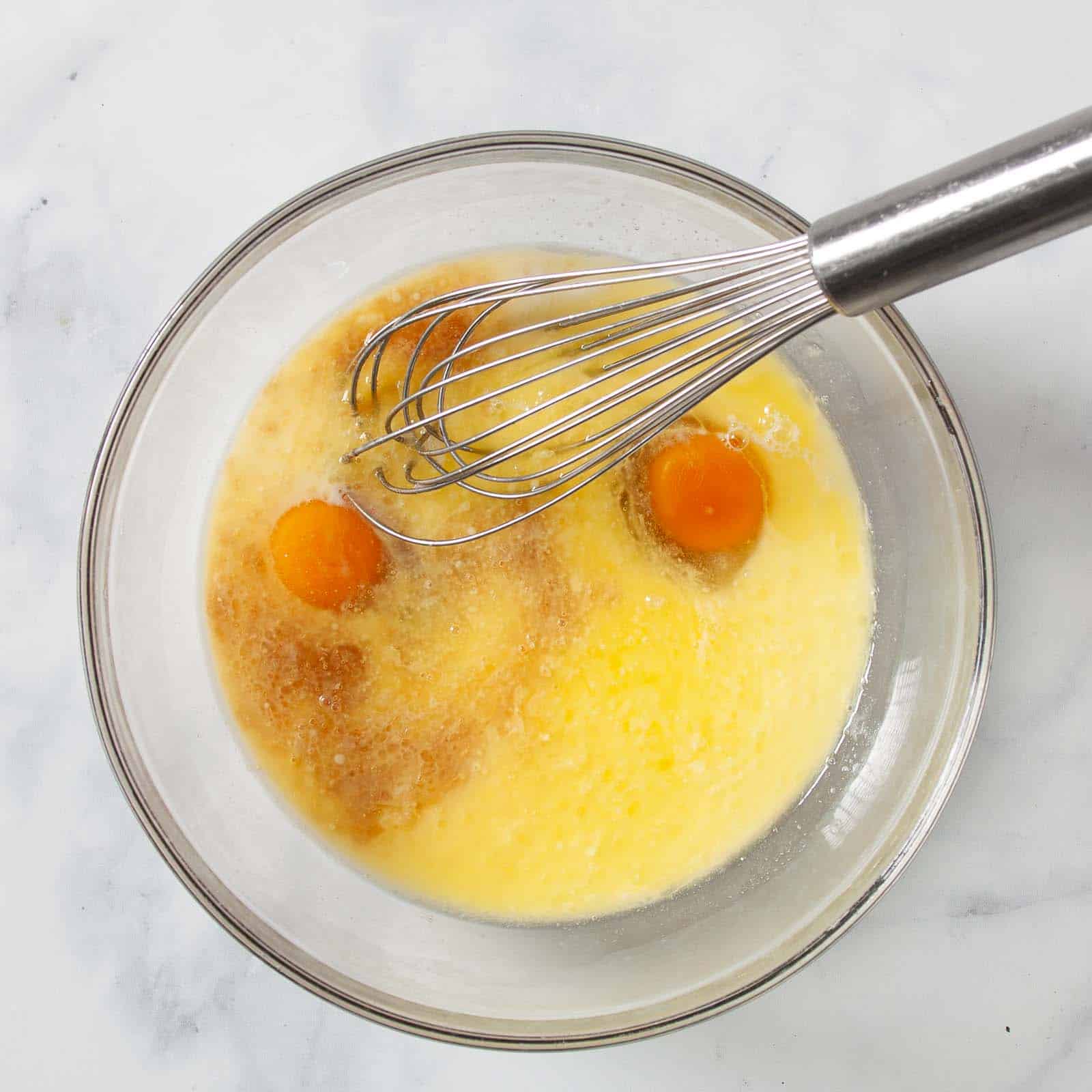 Using a whisk to combine the wet ingredients.