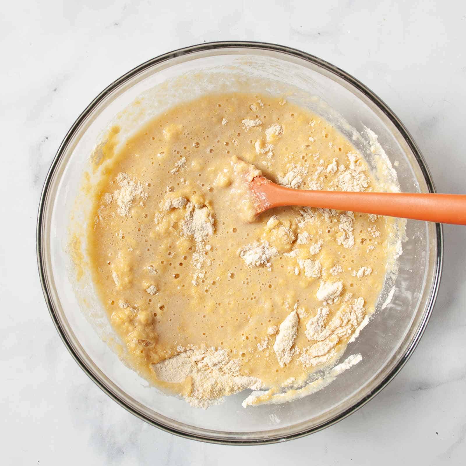 Combining the wet and dry ingredients in one bowl.