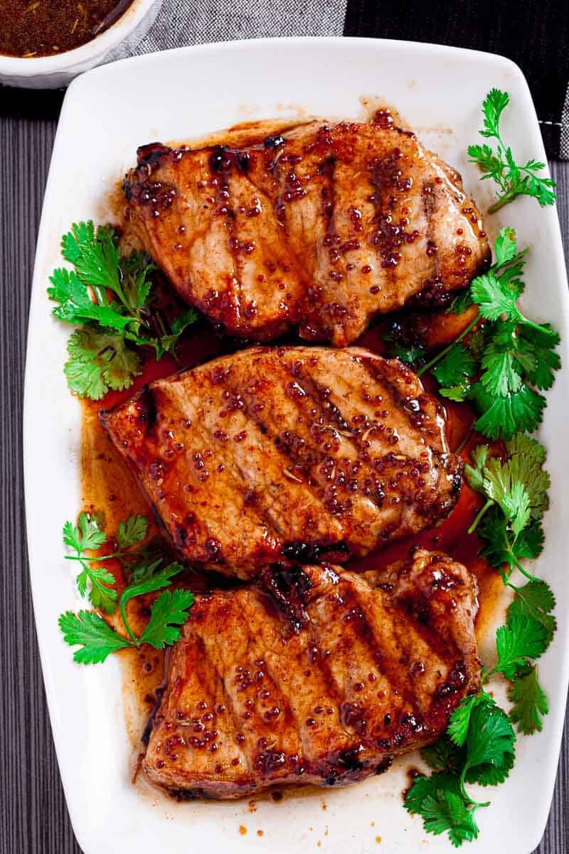 Overhead view of Honey Mustard Pork Chops on a white plate.