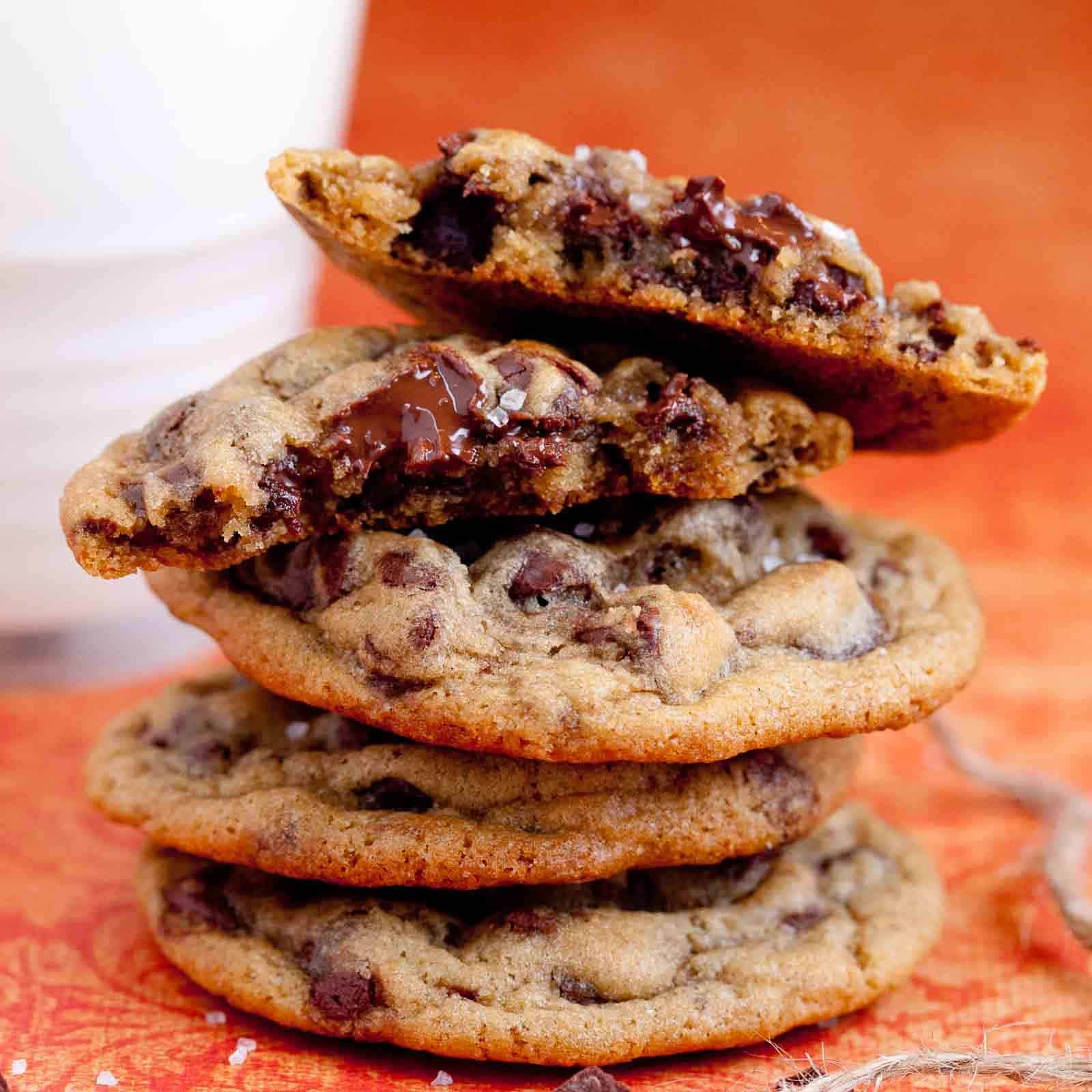Stack of no chill chocolate chip cookies with melty chocolate chunks and flaky sea salt.