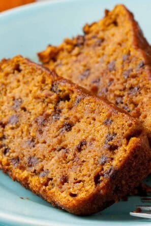 Slices of Vegan Pumpkin Bread on a ight blue plate.
