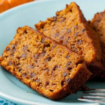 Slices of Vegan Pumpkin Bread on a ight blue plate.