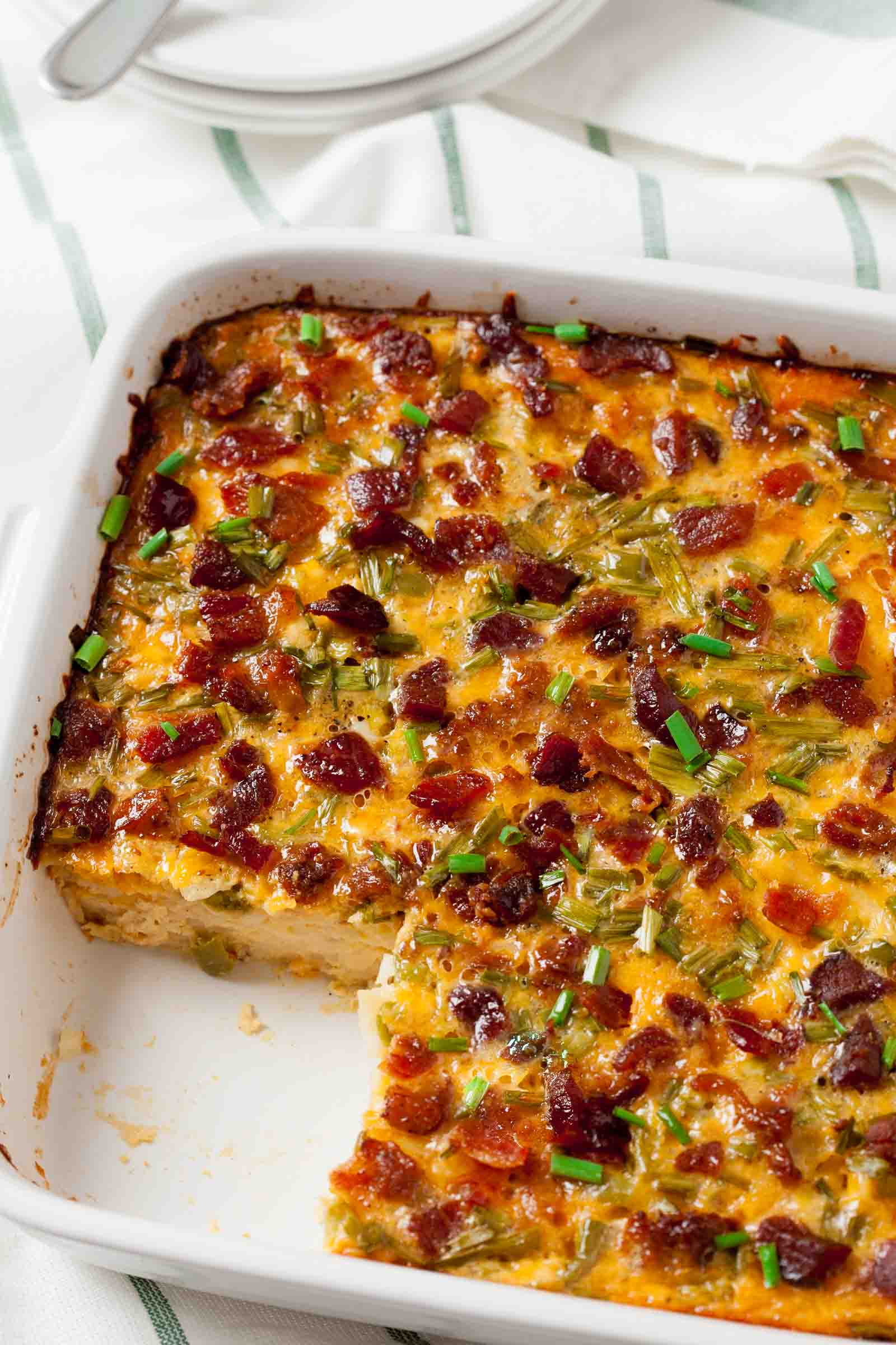 bacon and egg casserole in a white baking dish. 