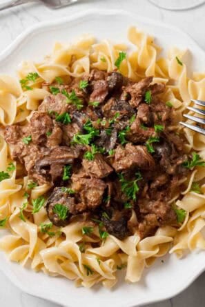 White plate full of slow cooker beef stroganoff.