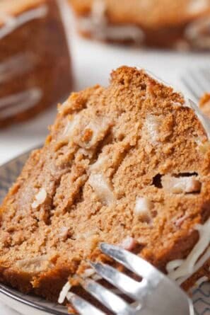 Close up of a slice of pear cake on a serving plate.