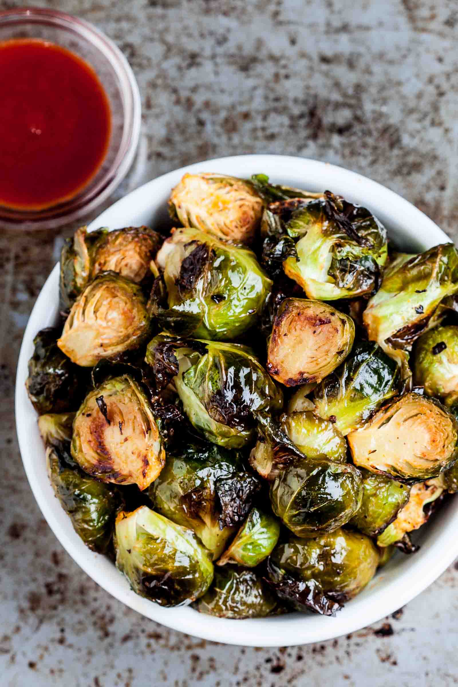 Overhead image of Oven Roasted Brussels Sprouts in a white bowl.